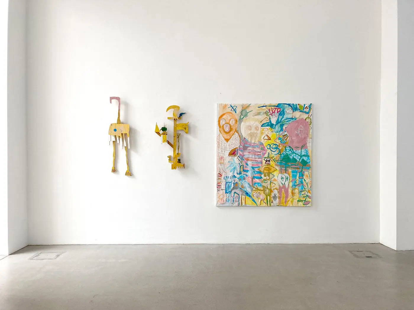 Installation view with wall sculptures and painting The Golden Age