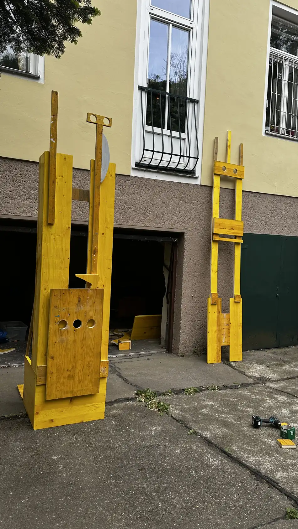 Echo Keepers 1 + 2, two wooden sculptures by Ernst Koslitsch, standing side by side before installation