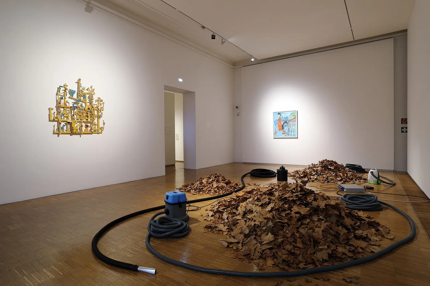Exhibition view with Hashtag Forever wall sculpture and The incompetent Dragon painting by Ernst Koslitsch, A Playground Guide to Getting Lost, Neue Galerie Graz