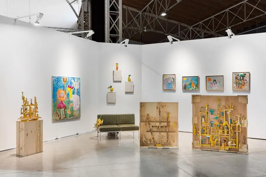 Installation view, Spark Art Fair booth, yellow wood sculptures and paintings