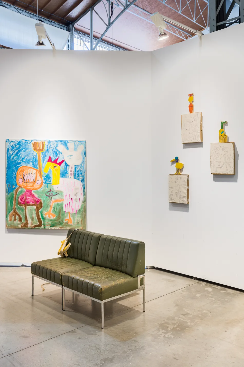 Booth corner view with a painting, sofa and small wall sculptures, Spark Art Fair booth, Ernst Koslitsch